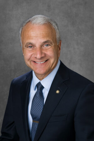 A professional headshot of James Doti.